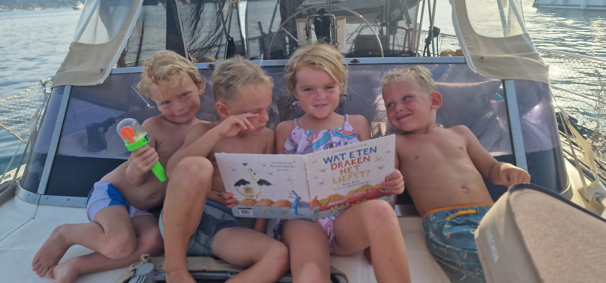 Reading kid on the sail boat Reading kid on the sail boat