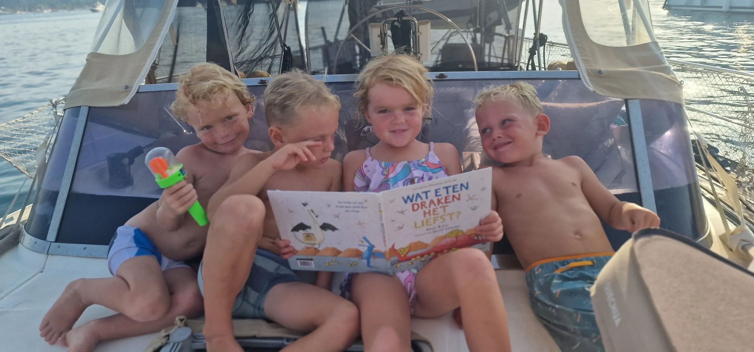 Reading kid on the sail boat {{brizy_dc_image_alt imageSrc=